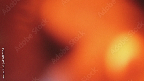 Foto An eye-catching grainy background showcasing warm orange hues with a soft golden light highlight
