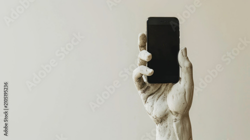 Marble hand holding modern smartphone against minimalist background