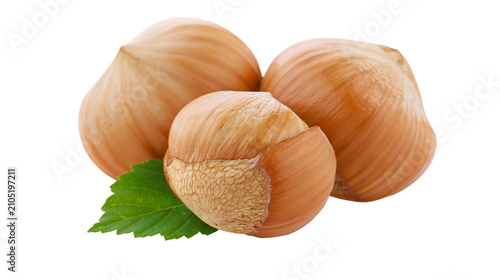 Fotografía Three whole hazelnuts with one partially open shell and green leaf