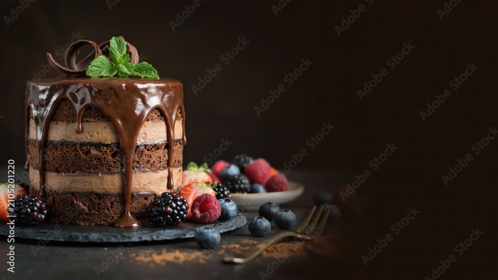 Fototapeta premium Chocolate cake with berries and chocolate sauce dessert