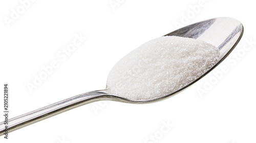 Granulated sugar piled on a metal spoon