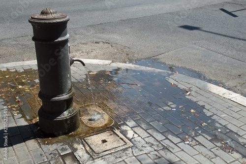 Nasone public water fountain flowing in rome street