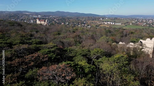 Drone flying by the ruins of an ancient amphitheater towards the city, 4k