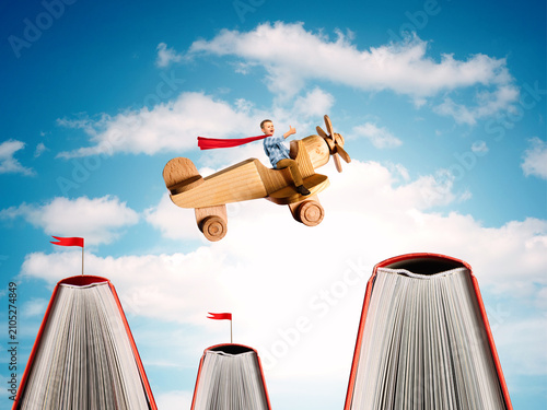 Imaginative concept of a child flying a wooden toy airplane above giant books. Symbol of learning, imagination, dreams, education, creativity, and childhood adventure.