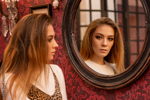 Foto Young Woman Reflected in a Vintage Mirror