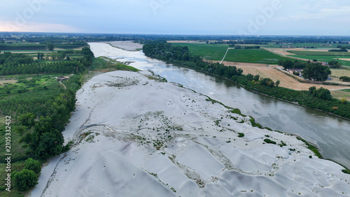 Canvastavla Po river displaying significantly low water levels and exposed sandbanks, highli