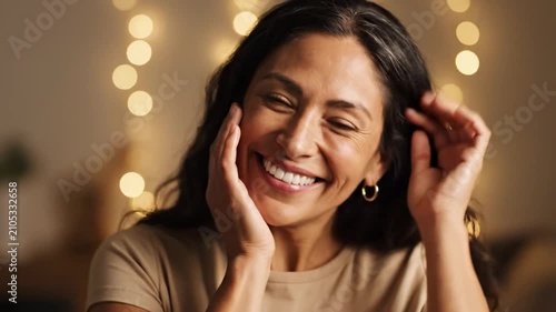 Happy smiling woman with hands framing her glowing face