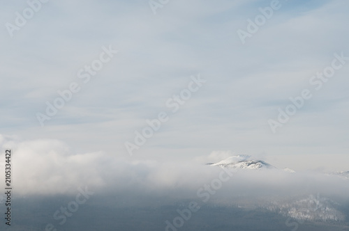 Winter view of national park Zuratkul with Big Uvan mountain ridge covered in the clouds, South Ural, Russian Federation