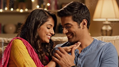 Happy young South Asian couple sharing intimate moment indoors.