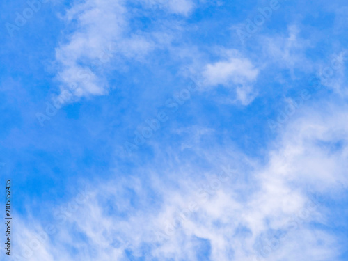 Принти на полотні Wispy white clouds spreading across a vivid blue sky