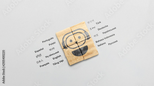 Konstfotografi Cardboard blocks showing a smiling robot with headphones, surrounded by names of
