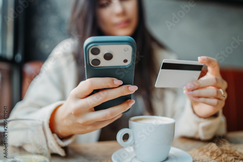 Woman shopping online with mobile phone and credit card