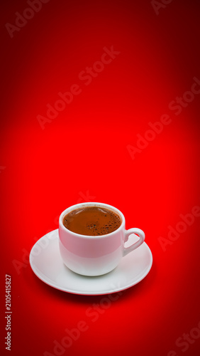 Traditional Turkish Coffee in a White Cup Isolated on a Vibrant Red Background 