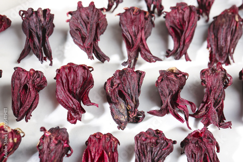 Bild auf Leinwand Dried Red Hibiscus Petals Chinese Traditional Herbal Tea Ingredients on White Ba