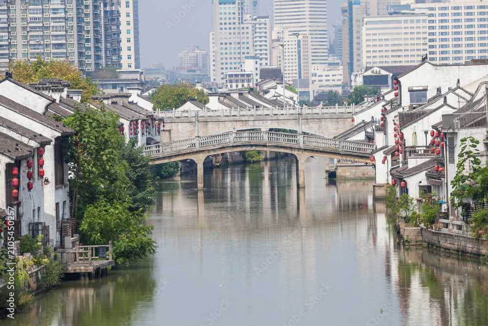 Fototapeta premium Wuxi Liyuan Canal with Traditional Architecture and Modern Skyline, Jiangsu
