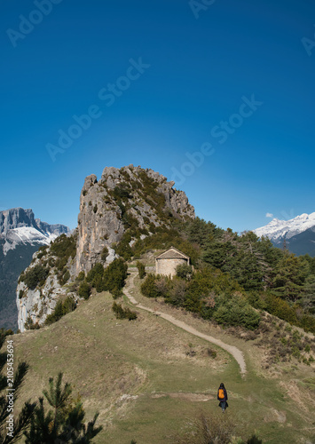 A young girl hiking up to the Chapel of San Juan and San Pablo in Tella, Huesca, located in the Aragonese Pyrenees.