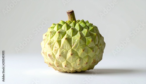 Close-up of a custard apple fruit on a white surface.