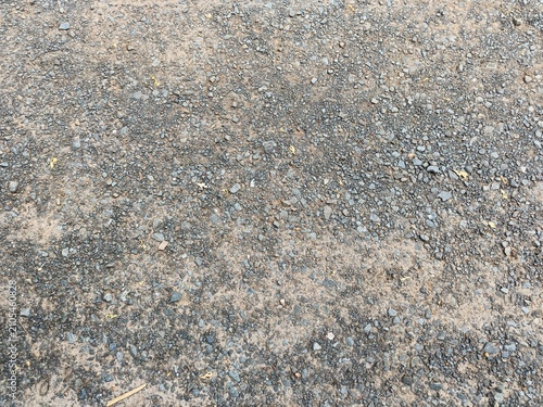Foto Rough gravel ground texture background with small grey stones and soil