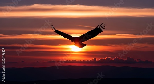 Airplane flying through orange and pink sunset sky.