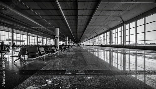 Black and White Airport Terminal Interior with Rows of Seats.
