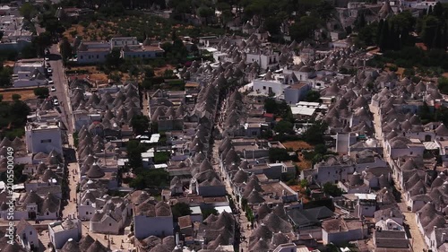 Aerial view flying over the famous trulli of alberobello, a unesco world heritage site with traditional apulian dry stone huts with a conical roof in puglia, italy