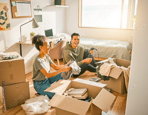 Couple unpacking boxes in a new home together.
