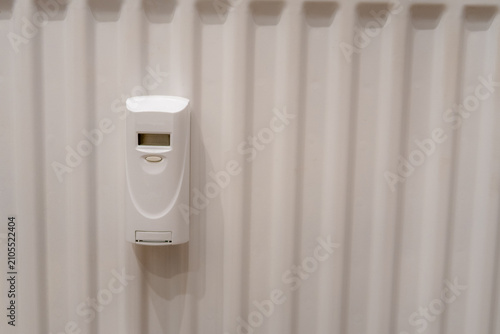 Digital Heat Cost Allocator Mounted on a White Radiator