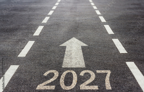 2027 text and white arrow on highway surface