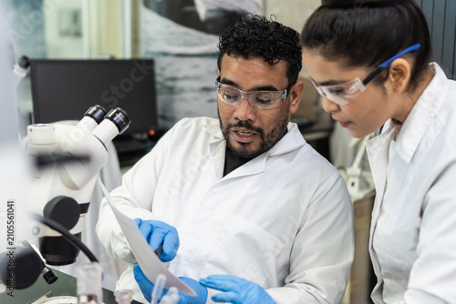 Scientists collaborating in laboratory conducting medical research