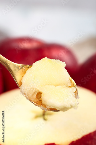 Konstfotografi Fresh Ice Cream on Spoon with Red Apples Background - Sweet Dessert Concept
