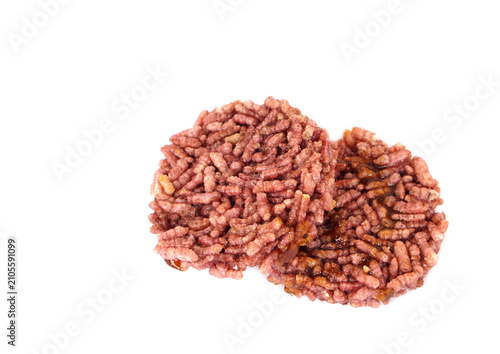 Traditional Thai watermelon rice crackers isolated on a white background. Crispy homemade rice snack with caramelized sugar, a popular Thai dessert and local delicacy with copy space.