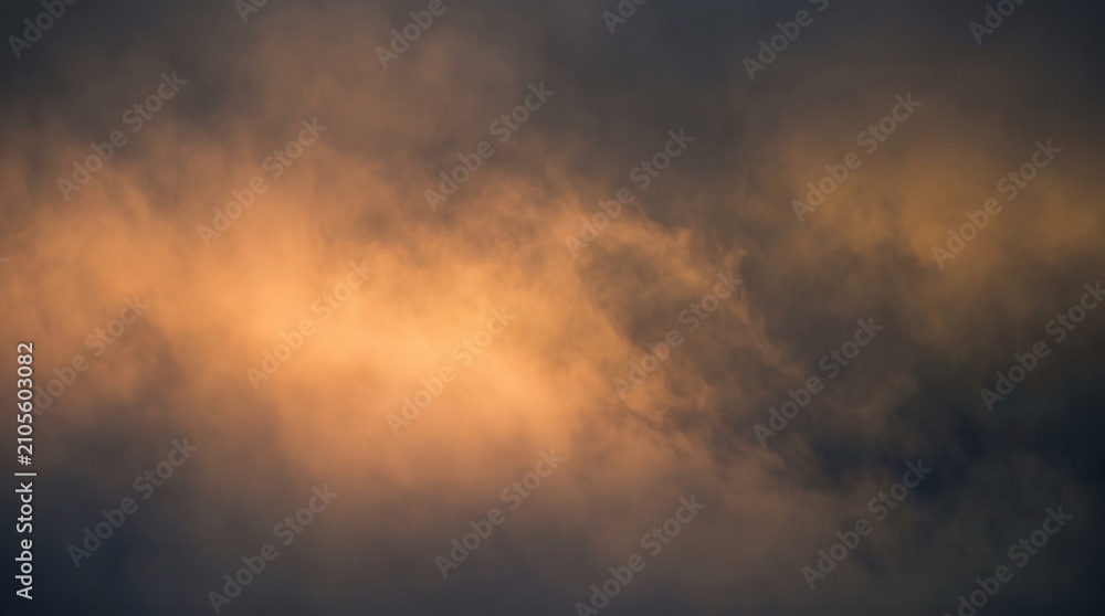 Fototapeta premium Eerie Orange Glow Illuminates Dark Stormy Clouds Creating a Dramatic Halloween Sky Background
