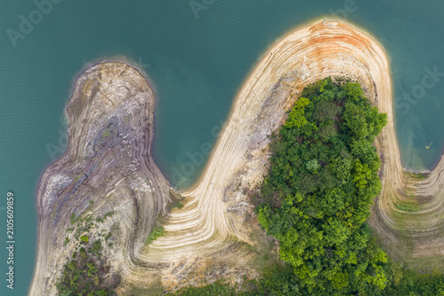 Quadro su tela Aerial view of wooded island and exposed shoreline in calm lake