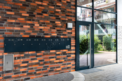 Front door and mailboxes of a modern apartment building in summer