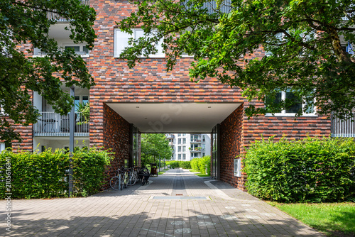 Driveway towards a modern apartment building in summer