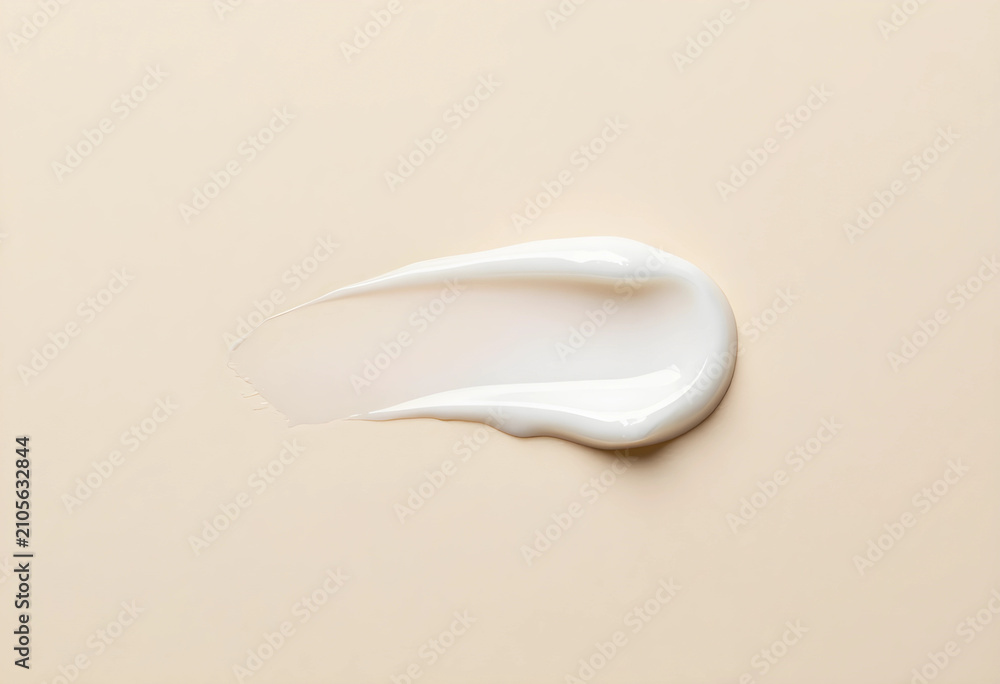 Obraz premium White cosmetic cream smear or lotion swatch on a light beige background, beauty product texture for skincare and makeup, the smooth
