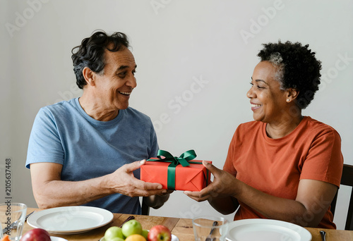 Happy senior couple exchang...