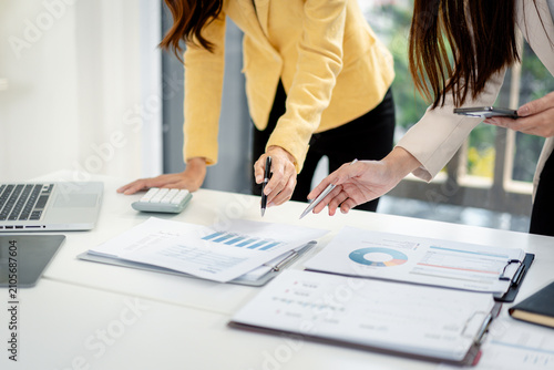 Professional business women analyze financial data reports discuss strategy planning project collaboration office meeting workspace management