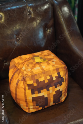 top view colorful square cube-shaped cushion placed on a brown leather sofa, object, decor, fashion, copy space