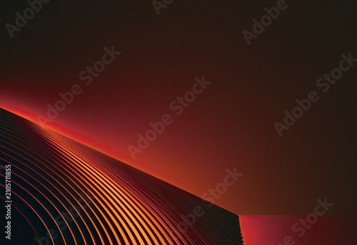 Abstract undulating metallic curves glow with warm, fiery light