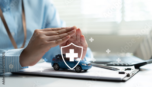 Принти на полотні Businesswoman hands protecting car with shield and cross icon at desk