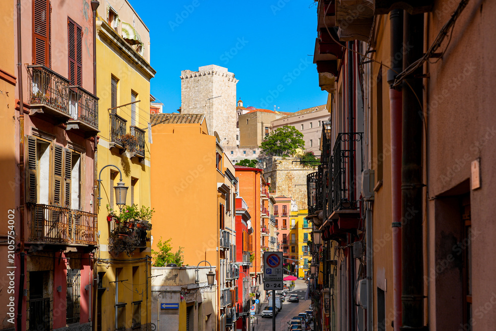 Fototapeta premium Historic colorful buildings and the Elephant Tower from Via Domenico Alberto Azuni in Cagliari, Sardinia, Italy