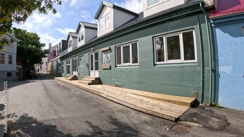 Narrow street and a traditional pastel green building in Torshavn, Faroe Islands