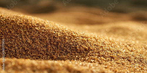 Close-up of fine brown sand grains with soft focus background