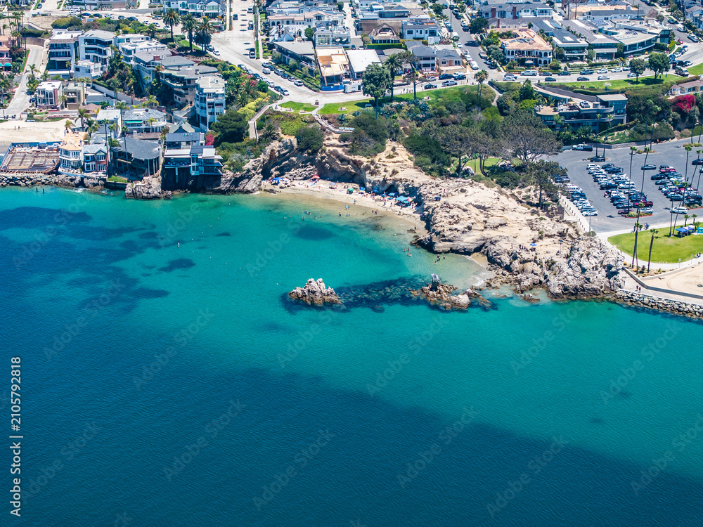 Fototapeta premium Aerial landscape view of Entrance Channel with Pirates Cove Beach next to Corona del Mar State Beach, located in Corona del Mar, a seaside neighborhood in the city of Newport Beach, California,