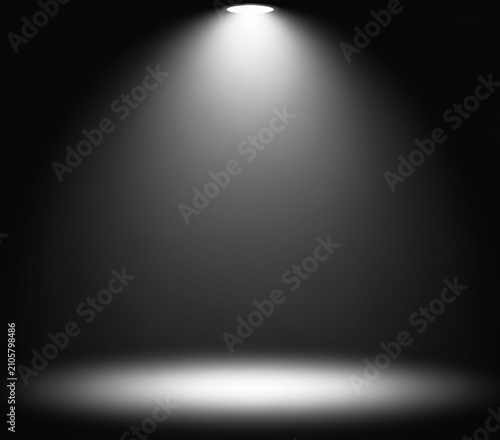 Dramatic theatrical stage spotlight shining on a dark floor