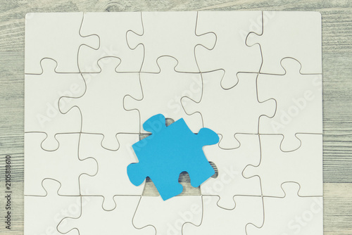 White and blue puzzle as symbol of Autism Spectrum Disorder