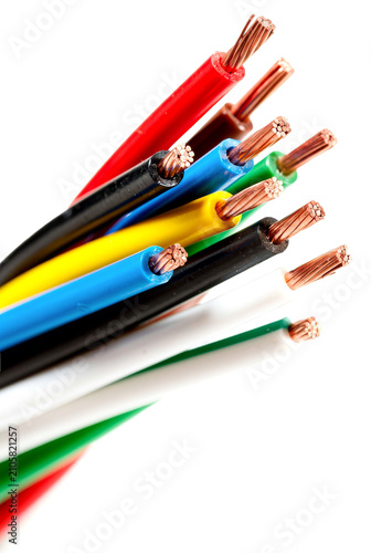 Close-up of multicolored stripped electrical wires with exposed copper cores, arranged in a fan shape and isolated on a transparent background.