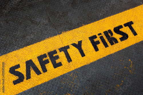 фотографія Safety first text on yellow and black striped surface industrial warning signage