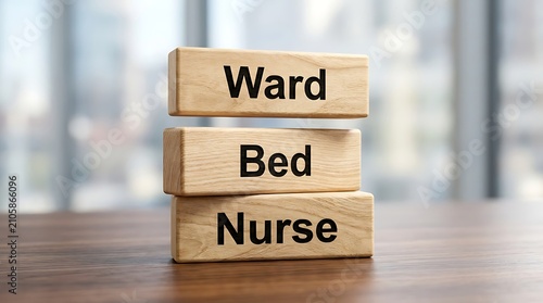 Wooden blocks spelling ward, bed, nurse on table stacked